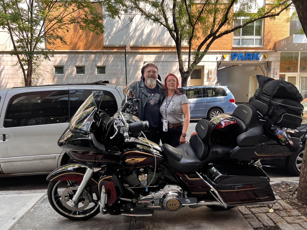 Simon Mills and Molley beside the loaded Harley-Davidson CVO before the Epic American Bike Trip
